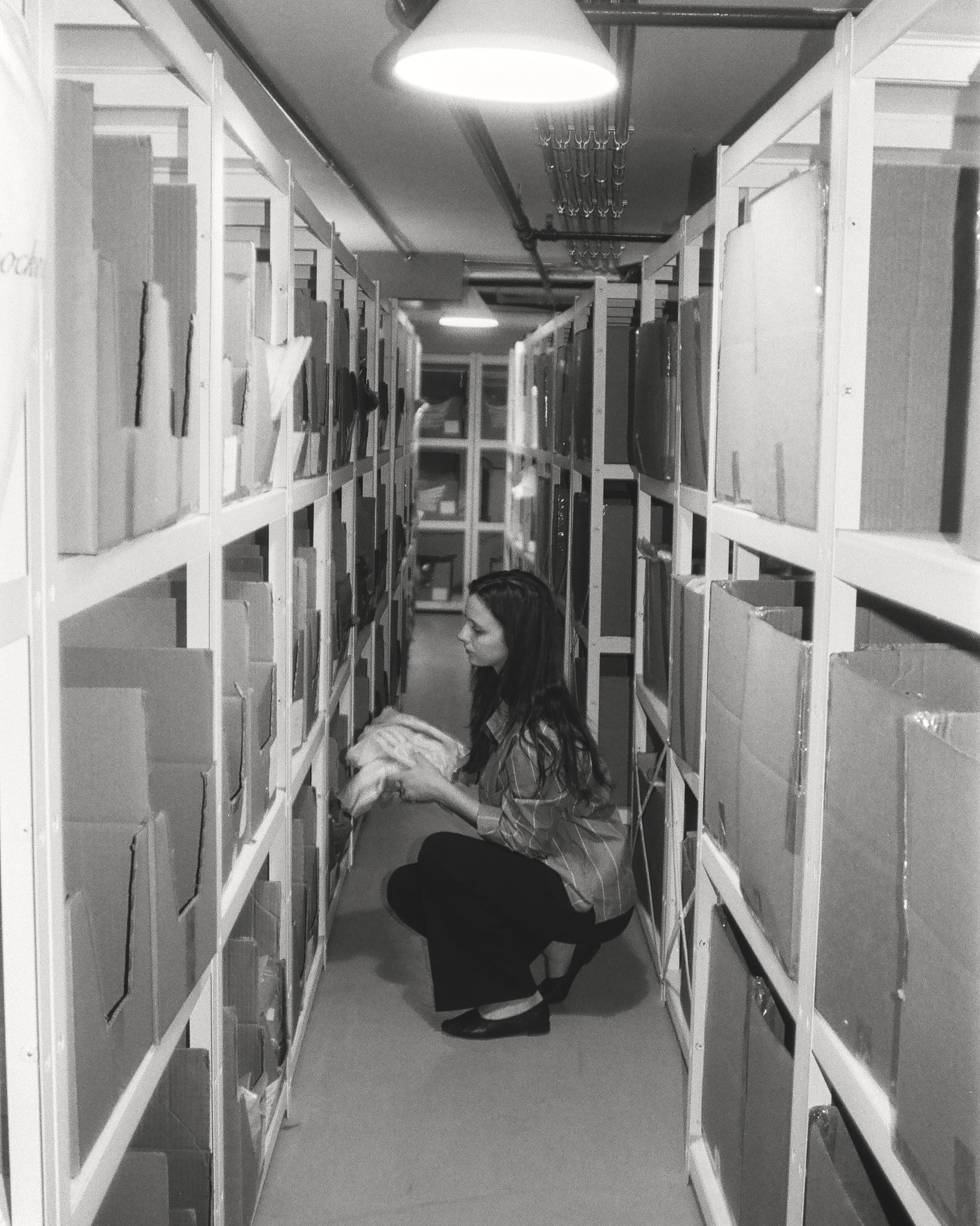 Maxine Livingston organizing inventory in their stock room