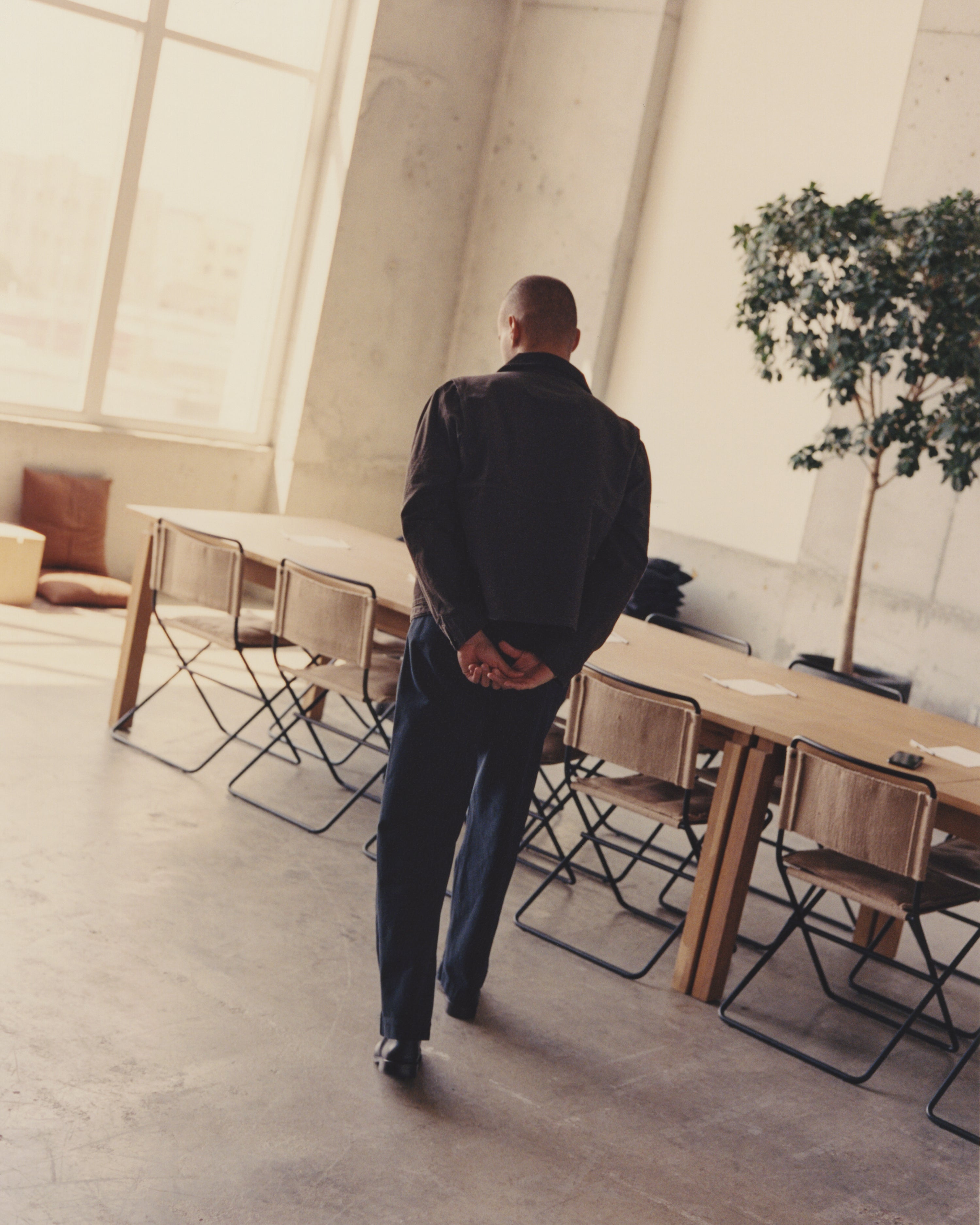 Michel Oscar Monegro in front of the shared work table at LAOBRA