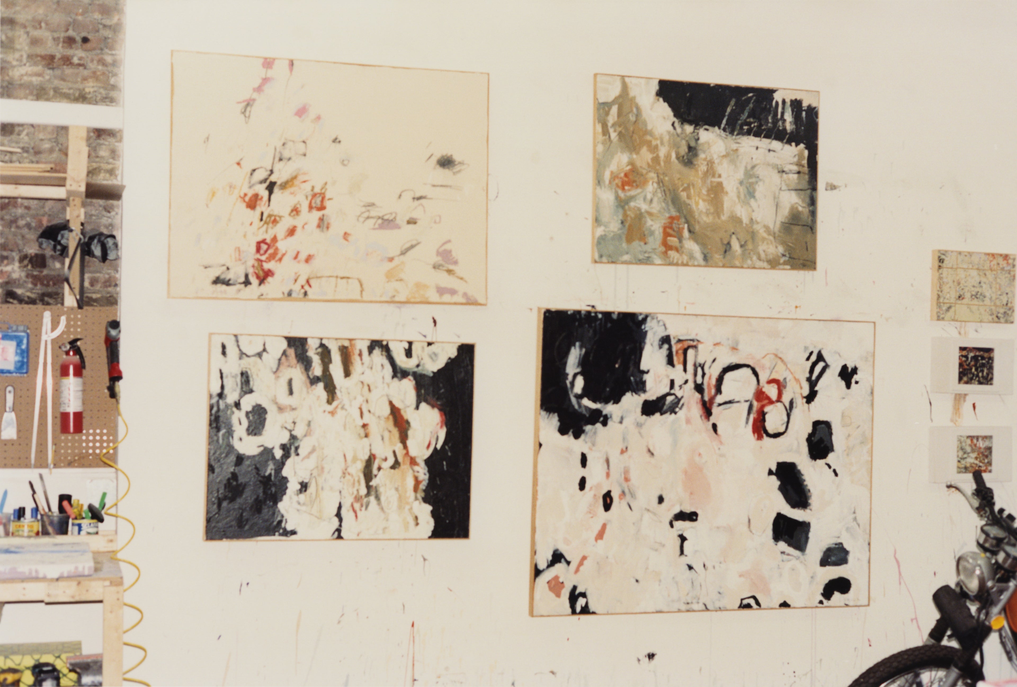 Joe Henry Baker's paintings hung up on his studio wall