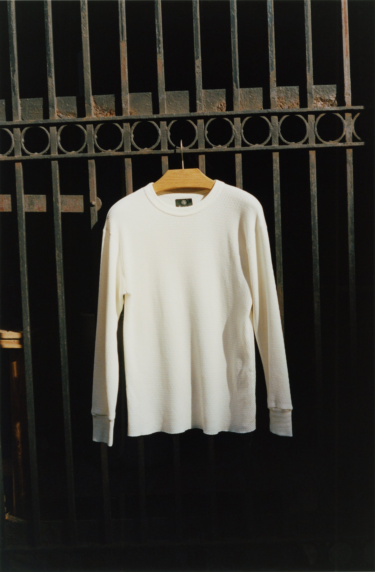 Thermal shirt hanging on a city fence in the sun