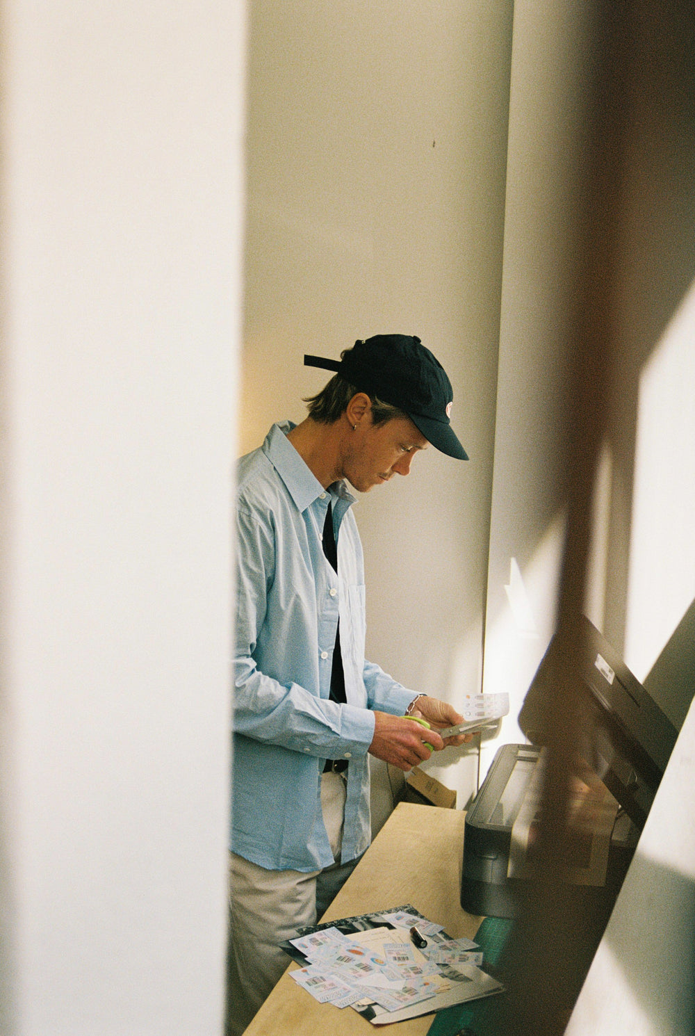 Guy cutting paper designs.
