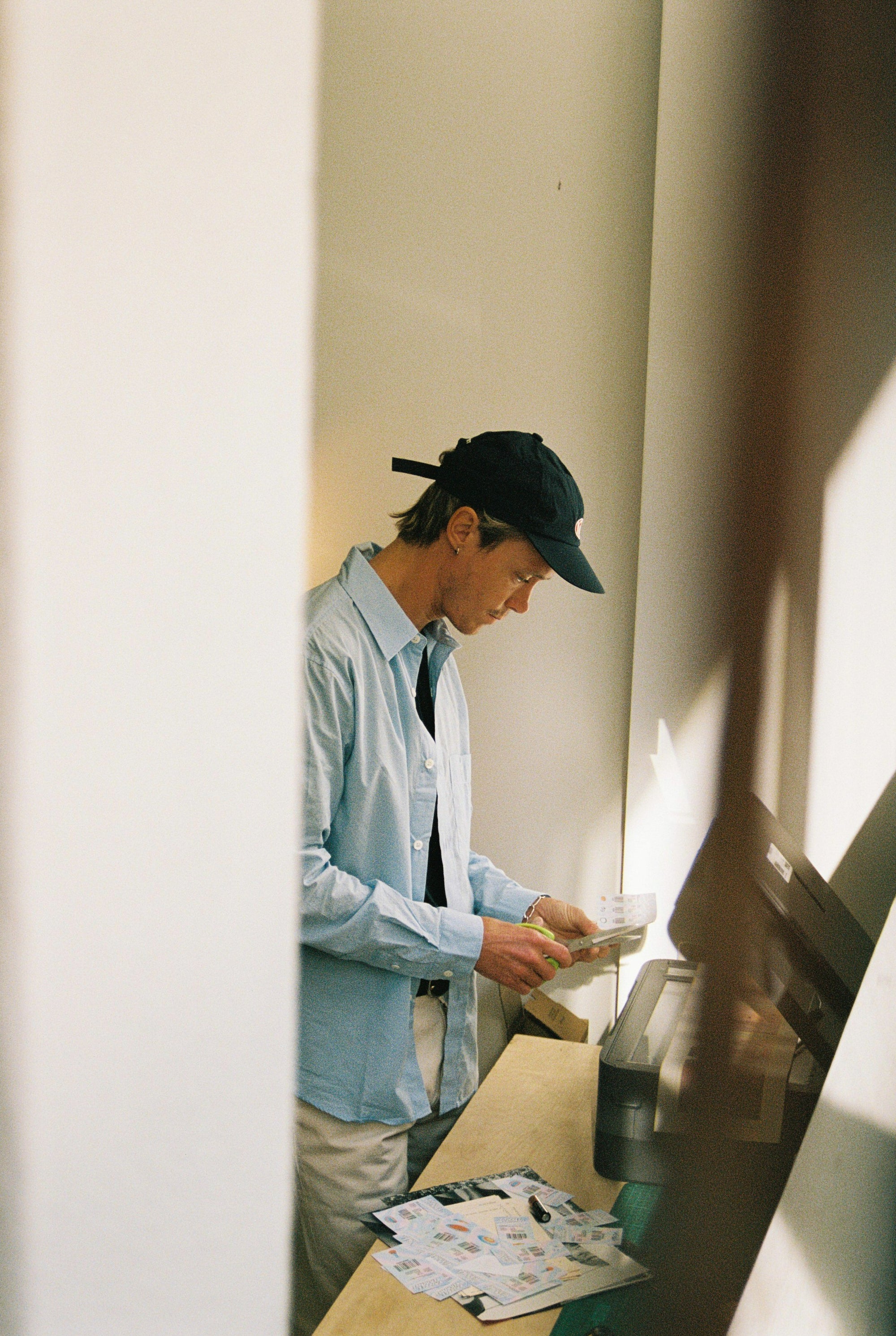 Guy cutting paper designs.