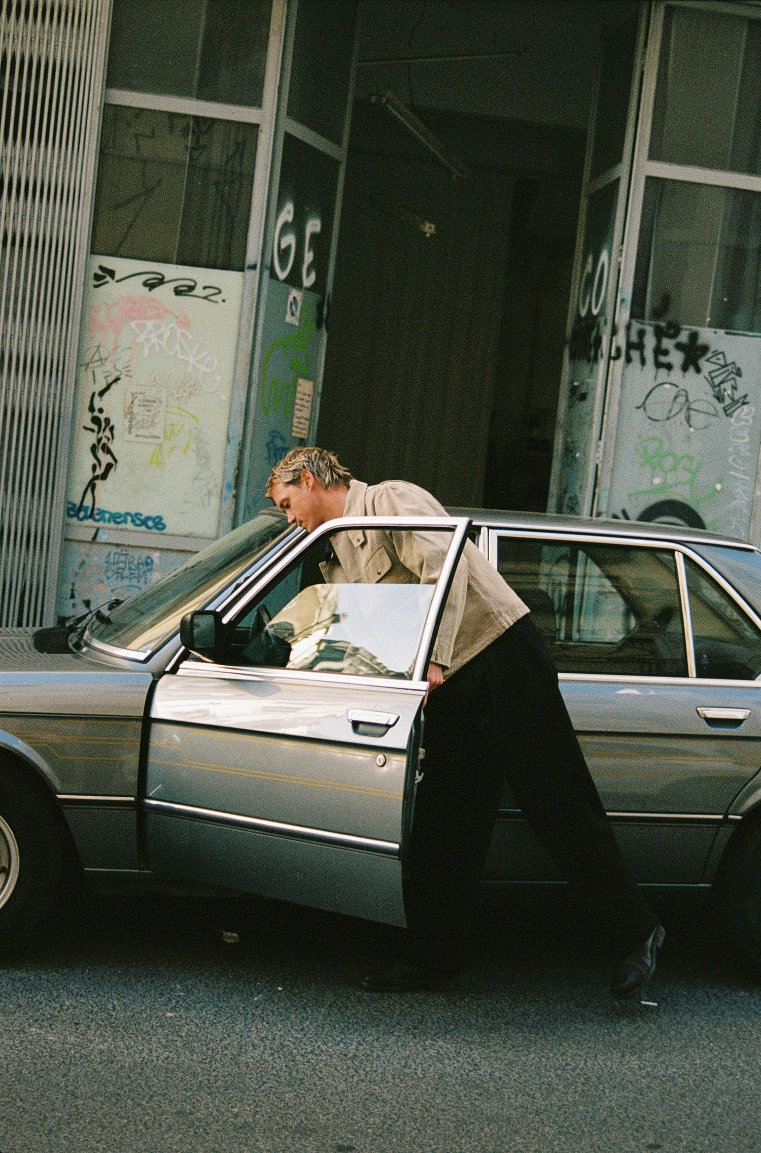Guy entering car.