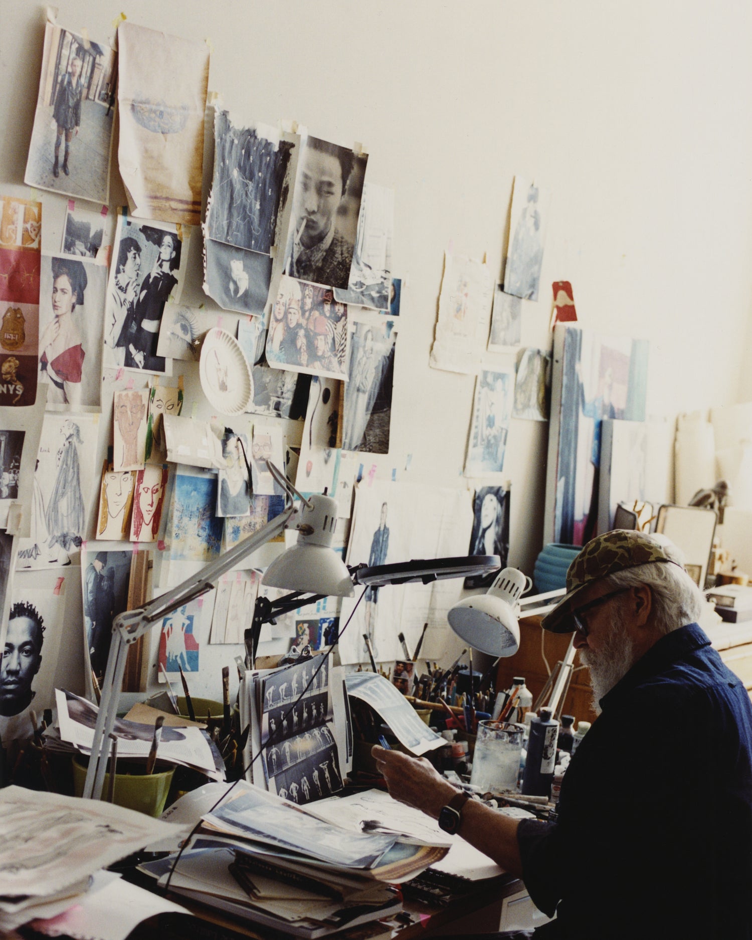 Richard Haines working at the desk in his art studio