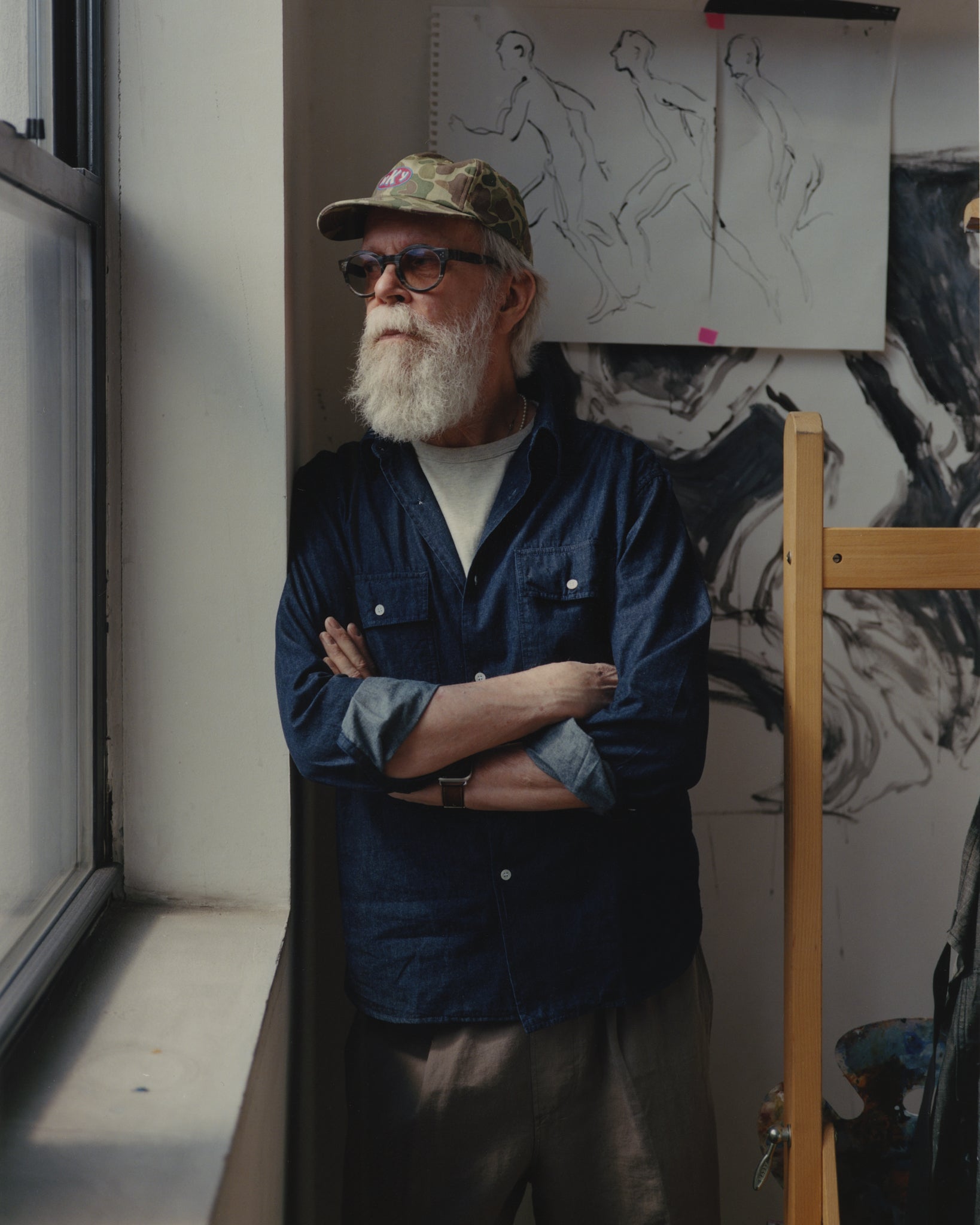 Richard Haines looking out the window in his studio