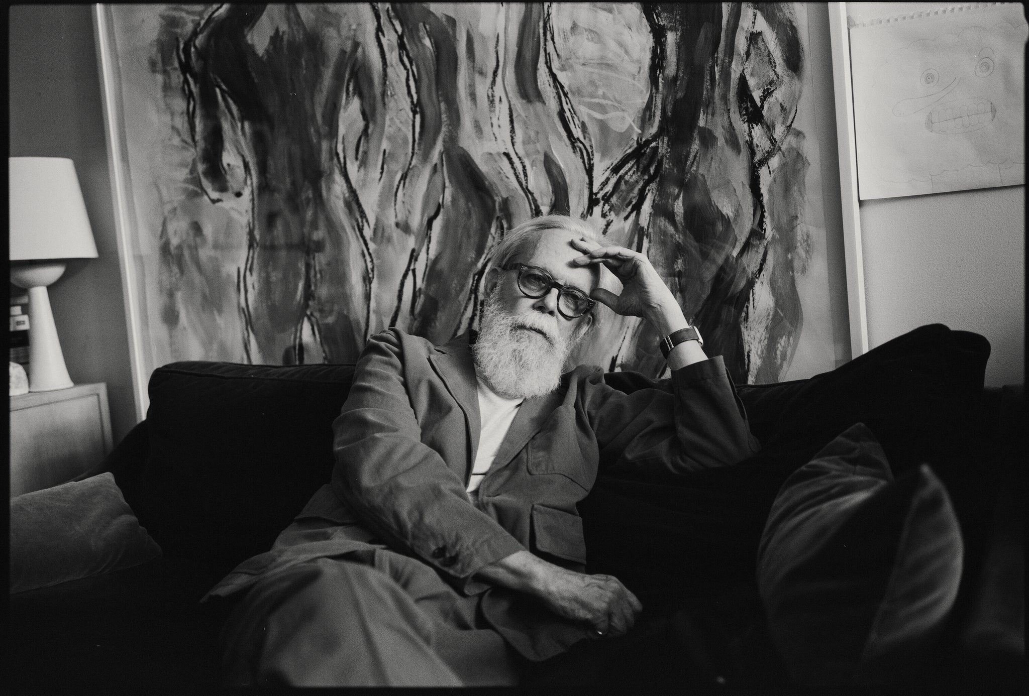 Black and white photo of Richard Haines in front of his painting